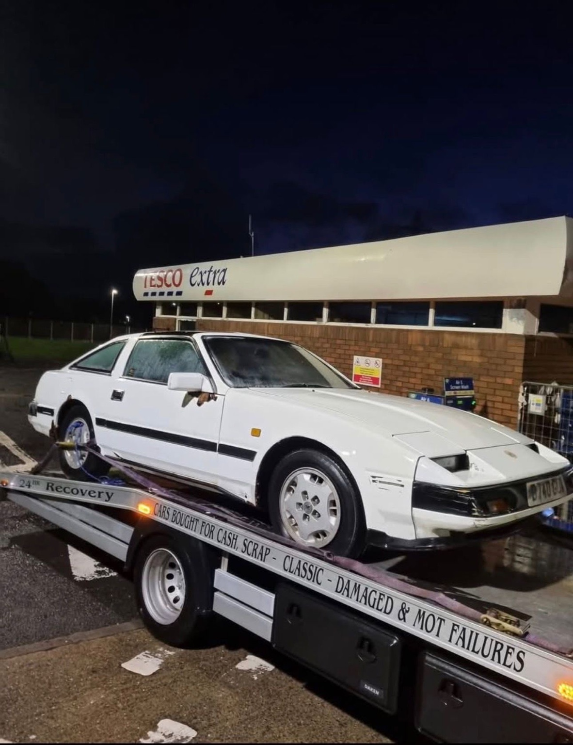 Classic car recovery service at night